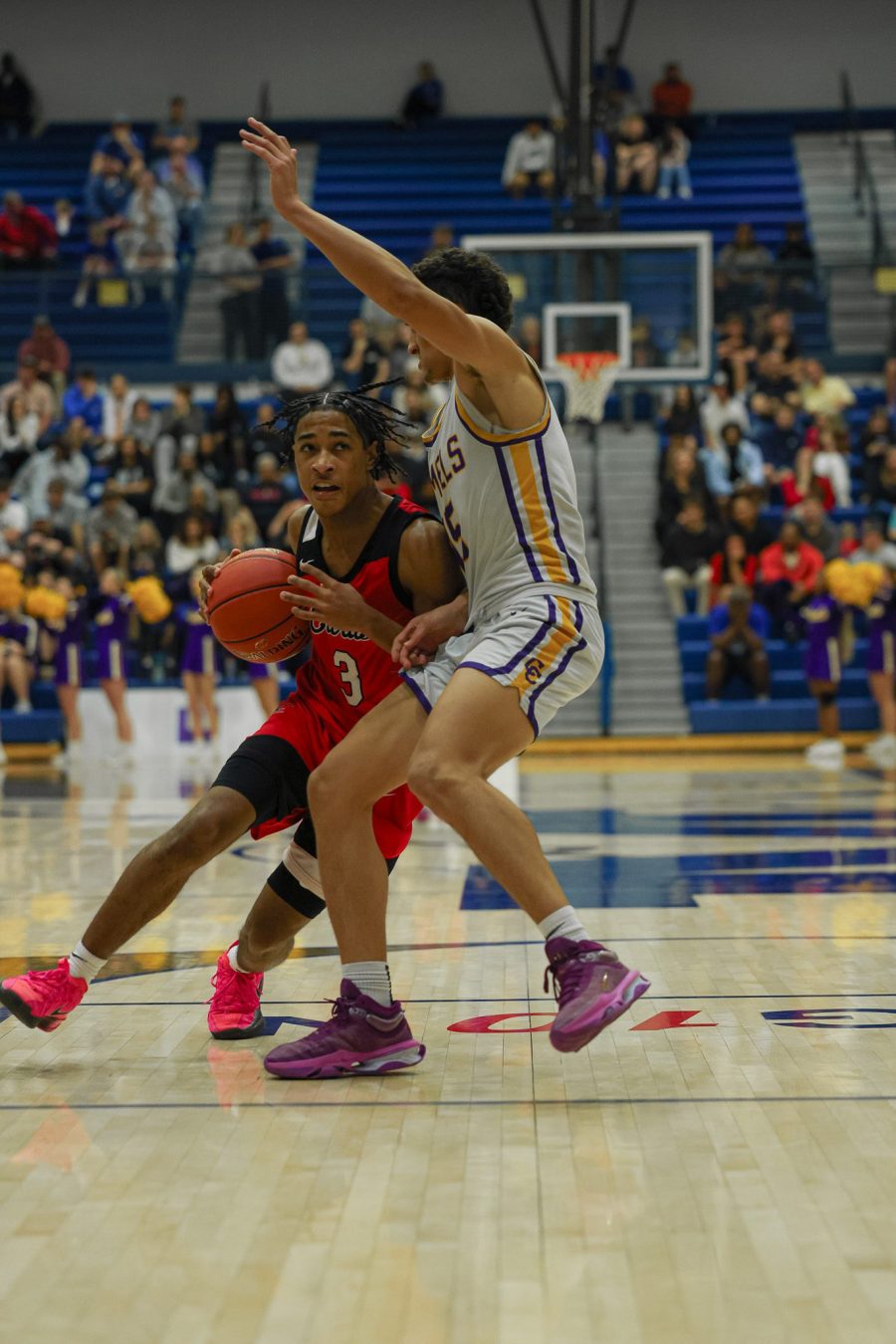 Malachi Ashford of GRC goes up for an and one layup against Garyn Jackson of Campbell
